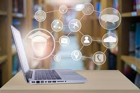 a laptop computer on a table with social media icons coming from the computer