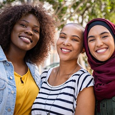 three diverse females posing for a picture