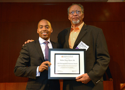 Khalil Gibran Muhammad, director of The Schomburg Center for Research in Black Culture, a research unit of The New York Public Library, presents Walter Dean Myers ’84 with the Distinguished Alumni Award.